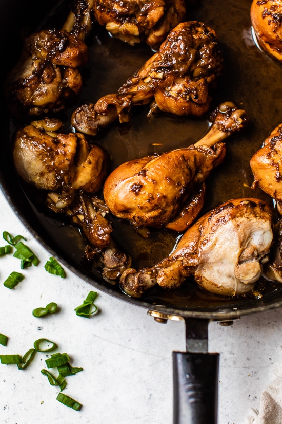 Asian Chicken drumsticks in a skillet.