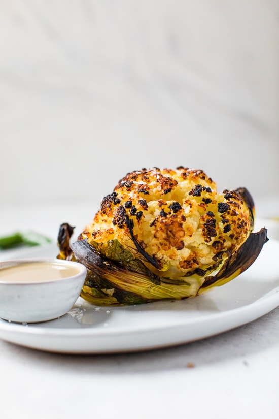 This simple, Whole Roasted Baby Cauliflower is perfectly charred on the outside and tender in the middle. Made with just four ingredients – salted water, extra-virgin olive oil, coarse sea salt—and cauliflower.