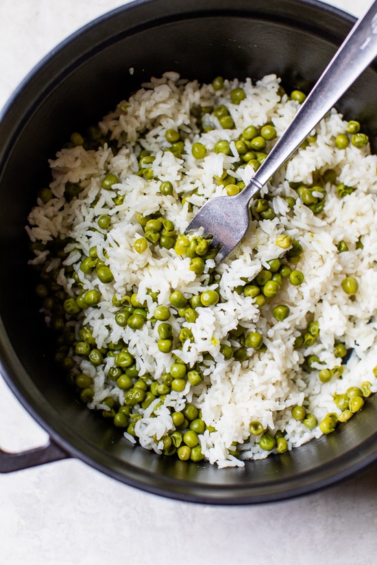 This simple Baked Rice and Peas dish uses pantry and freezer staples, a great side dish to go along with grilled shrimp or chicken.