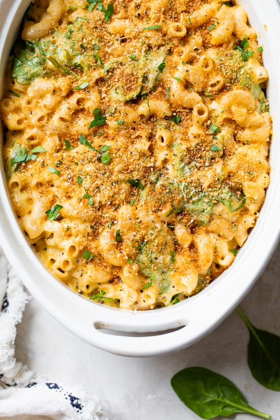 This creamy baked mac and cheese recipe is a lighter version of the classic recipe with added fiber from spinach. It's comfort food at it's finest!