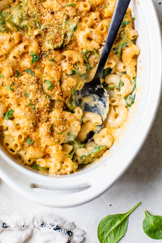 This creamy baked macaroni and cheese recipe is a lighter version of the classic recipe with added fiber from spinach. It's comfort food at it's finest!