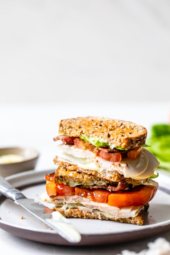 A classic Turkey Club sandwich made healthy, piled high with turkey breast, bacon, lettuce, and tomato on whole grain bread, the perfect easy lunch.