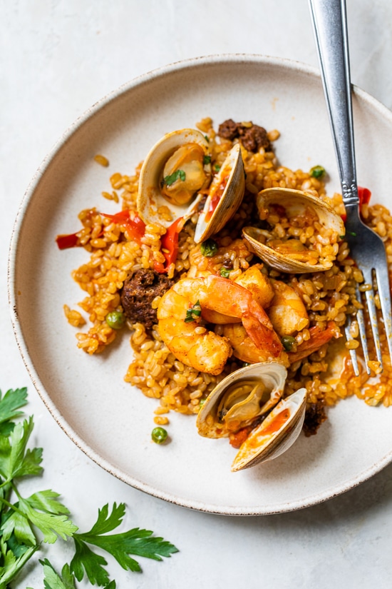 This easy seafood paella, made with shrimp, clams and chorizo is a delicious one-pot dish!