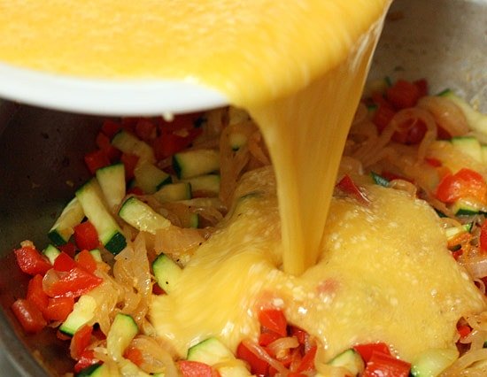 Pour egg mixture over sauteed veggies.