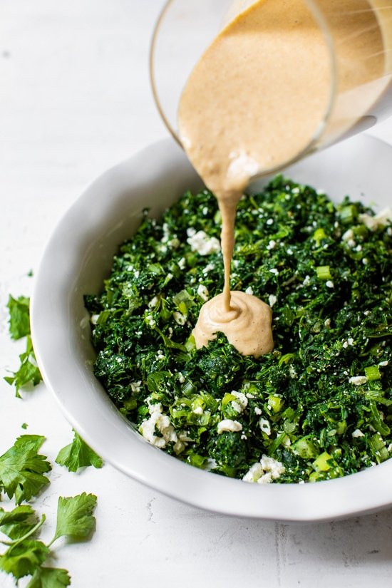 pouring batter onto spinach