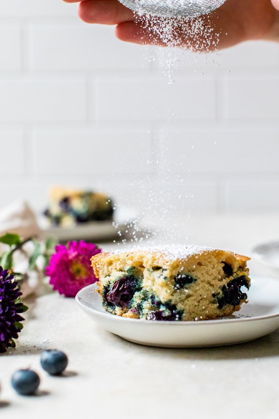 A slice of Blueberry Buttermilk Cake on a plate.