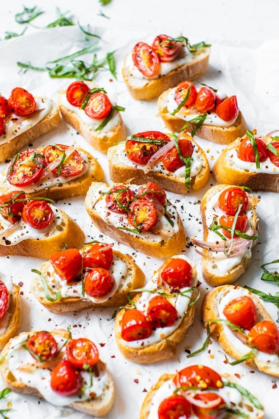 Whipped Ricotta Toast with Roasted Tomatoes on a white background